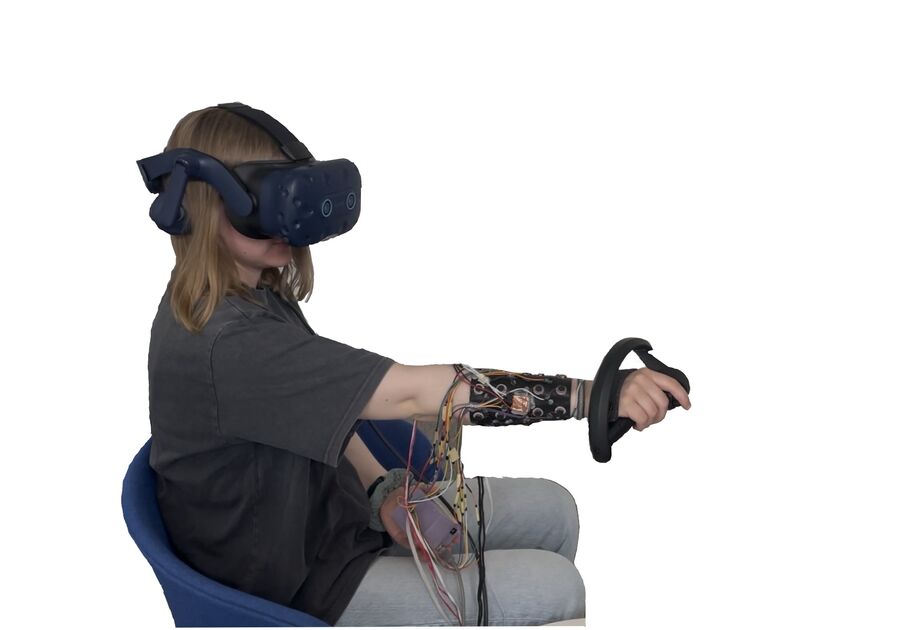 Participant wearing haptic sleeve during VR user study